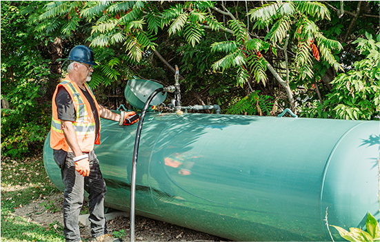 fuel commercial tanks and employee refueling the tank